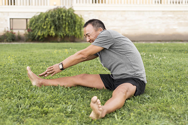 Middle-aged man stretching.