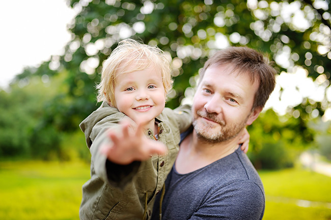A middle-aged man with his son in the park.
