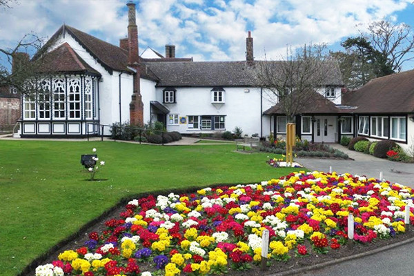 Front of Milton House with flowers in bloom