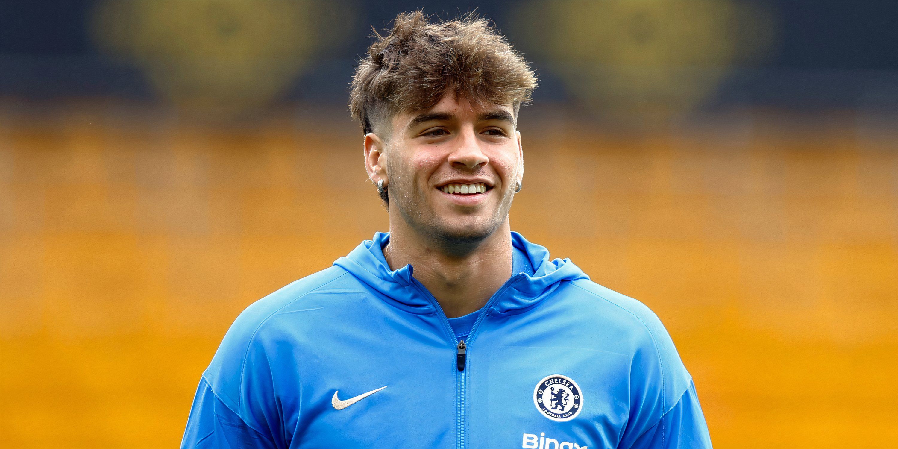 Chelsea striker Marc Guiu smiling before a pre-match warm-up