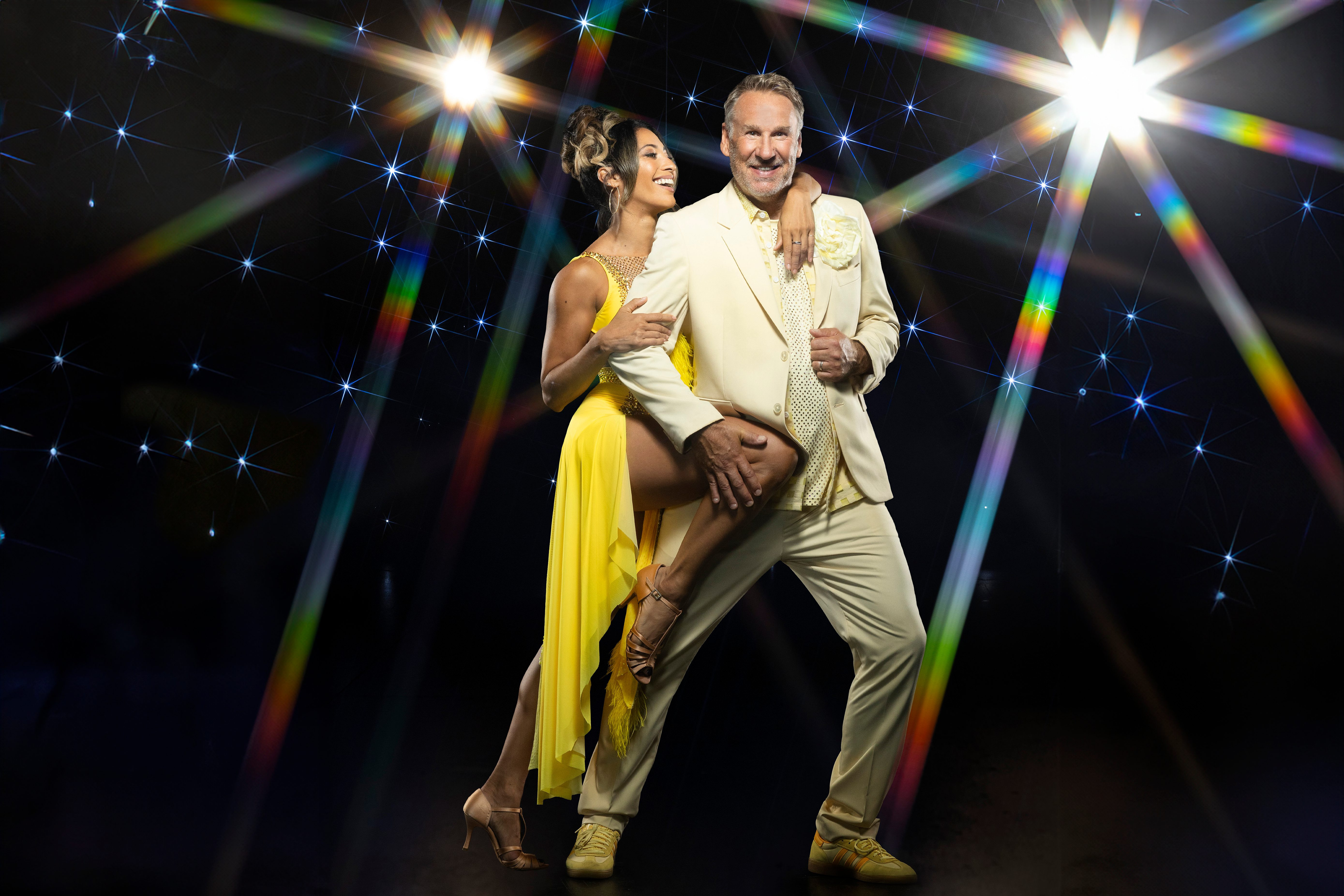 Paul Merson and Karen Hauer for Strictly Come Dancing outfits on a glitzy star background.