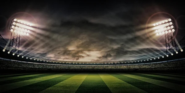 Illuminated football stadium at night