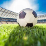 Close-up view of a soccer ball on grass in a stadium