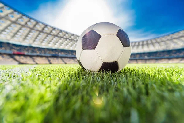 Close-up view of a soccer ball on grass in a stadium