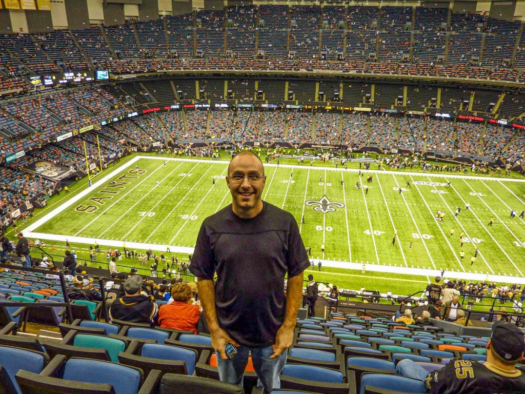 Dan Brewer, owner of UltimateSportsRoadTrip.com, stands at his seat for the Saints vs Patriots game on Monday Night Football