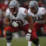 Offensive lineman blocking during a football game
